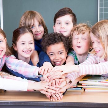 Hnde aufeinander Freude in der Schule Kinder halten ihre Hände in die Mitte